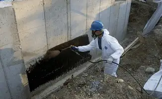 Professional waterproofing the exterior walls of the basement in Overland Park, KS